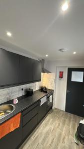 a kitchen with a sink and a counter top at Abena' Villa in Moffat +6 photos