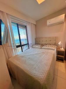 a bedroom with a bed and a large window at Apartamento, Vista Mar, Praia de Boa Viagem, Hóspedes Exigentes! in Recife +54 photos