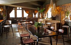 a restaurant with tables and chairs and windows at Piccadilly Central in Manchester