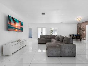 un salon avec un canapé et une table dans l'établissement The Chill Sunny Casa Near Beaches, à Miami Lakes