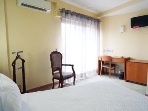 Uma TV ou centro de entretenimento em Hotel São Francisco