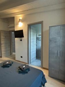 a bedroom with a bed and a sliding glass door at 5 Zimmer Rooms ''Rosa'' in Siniscola