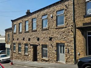 an old brick building on a city street at Luxury studio apartment, Skipton in Skipton