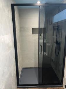 a shower with a glass door in a bathroom at Guest House with parking in Bournemouth in Longham +11 photos