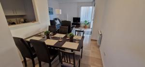 a dining room and living room with a table and chairs at Casa Colina Roda Golf in San Javier