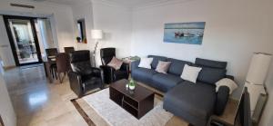 a living room with a blue couch and chairs at Casa Colina Roda Golf in San Javier
