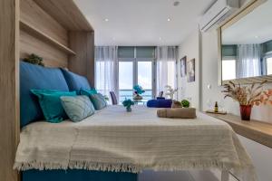 a bedroom with a large bed with a blue headboard at Estudio Loft Horizonte Playa Fossa Calpe in Calpe +50 photos
