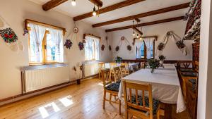 a dining room with a table and chairs and windows at Breb 335 Accomodation & Garden in Breb
