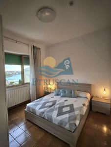 a bedroom with a bed with a sign on the wall at Etruscan Blue House in Piombino +13 photos