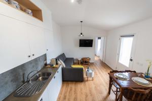 a kitchen and living room with a couch and a table at Azores Element in Livramento