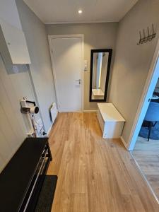 an empty room with a staircase and a mirror at Comfy and cozy apartment in Tromsø