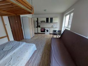 a small bedroom with a bed and a kitchen at Awesome studio in Košice