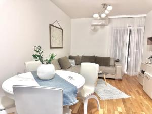 a living room with a table and a couch at Vália in Tivat