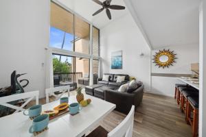 a living room with a table and a couch at Just Steps to Beach with 2 King Beds and Centrally Located in Kihei +29 photos