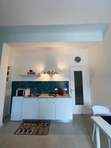 a kitchen with white cabinets and a counter top at Al Tribunale Guest House in Palermo