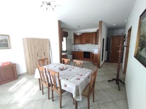 a kitchen and dining room with a table and chairs at La Mergozzina in Mergozzo