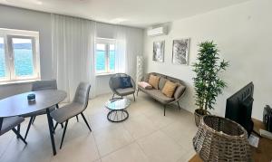 a living room with a couch and a table at Stella Apartments in Kaštela