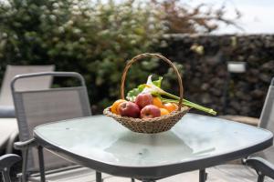 a basket of fruit sitting on top of a table at Azores Element in Livramento