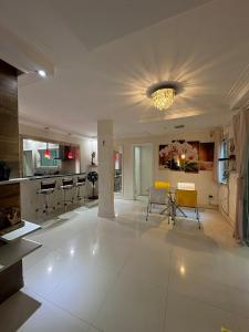 a large living room with a large white tile floor at hospedagem alexandres in Cabo Frio