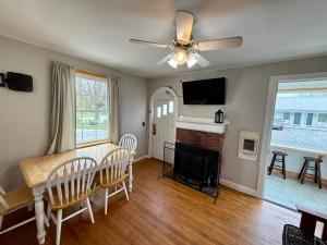 a dining room with a table and a ceiling fan at Eden Village Motel and Cottages in Bar Harbor