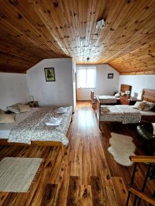 a room with three beds and a wooden ceiling at River Point, kuća za odmor in Žažina