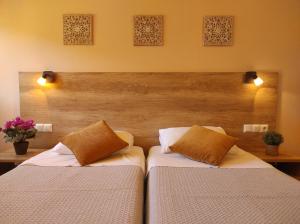 two beds in a bedroom with two pillows at Donatos Parga - Apartments & Studios in Parga
