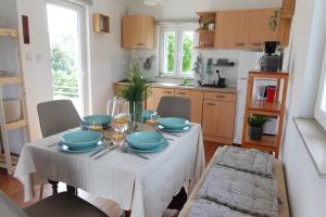 a kitchen with a table with blue dishes on it at Solar Hill Home in Žrnovo