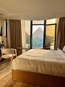 Voodi või voodid majutusasutuse Neom Pyramids Valley Boutique hotel toas