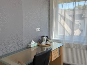 a kitchen with a table with a tea kettle on it at CoBa in Baden-Baden