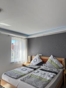 a bedroom with a large bed with a window at CoBa in Baden-Baden