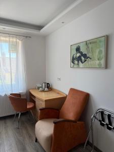 a living room with a chair and a desk at CoBa in Baden-Baden