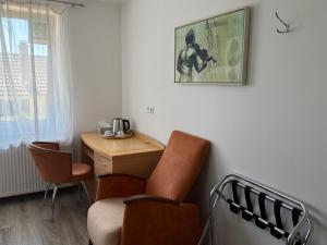 a room with a chair and a desk and a picture at CoBa in Baden-Baden +5 photos