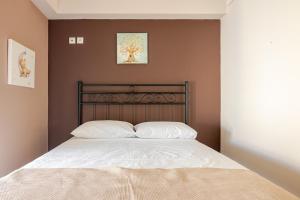 a bedroom with a bed with white pillows on it at "La Vie Est Belle" by the sea Rethymno in Rethymno +37 photos