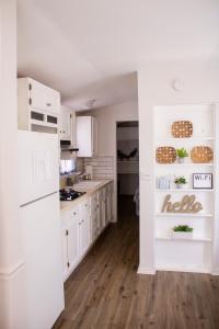 a kitchen with white cabinets and a white refrigerator at Clyde's Cabin with a private Hot Tub in Carthage