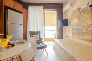a room with a bed and a table in a room at "La Vie Est Belle" by the sea Rethymno in Rethymno