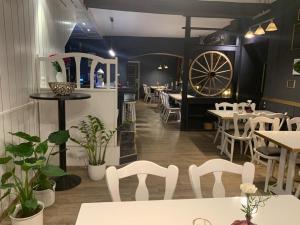 a restaurant with tables and chairs and a large wheel at Deutsches Haus in Malchow