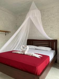 Tempat tidur dalam kamar di Alen's Stay&surf