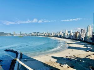 a view of a beach with a city in the background at Apartamento frente mar in Balneário Camboriú