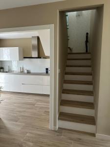 a stairway in a kitchen with a staircase in a house at Villa Doce in Puentecesures +41 photos