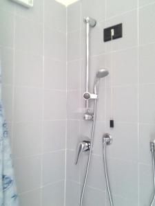 a shower with a shower head in a bathroom at Hotel Aurora in Loano