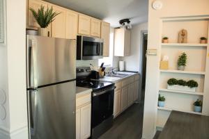 a kitchen with a stainless steel refrigerator and a sink at Oak Ridge Oasis in Carthage