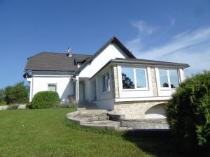 a white house with some stairs in a yard at House Biba & Leona in Rastovača