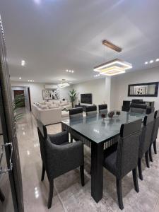 a dining room and living room with a table and chairs at Charming Apartment - Near Cairo Airport in Cairo