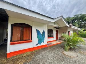 una casa con una farfalla dipinta sul lato di Kalunay Hostel a Puerto Viejo Altre 23 foto