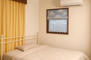 a bedroom with a bed and a window at MtFuji Homestay Leoya in Fuji +74 photos