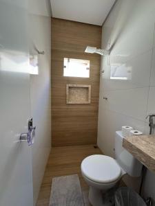 a small bathroom with a toilet and a window at Pousada Bem Estar in Carolina