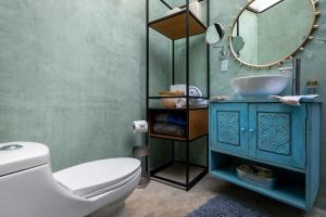 a bathroom with a blue sink and a mirror at De Frente al Sol Teotihuacan in San Juan Teotihuacán +67 photos