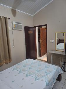 a bedroom with a bed and a sink and a mirror at Casa Serra Macaé in Água Boa +17 photos