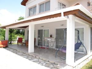 a patio with awning on the side of a house at Crescent Villa in Dalyan