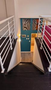 a staircase in a room with two bunk beds at Beachview Apartment in Hout Bay